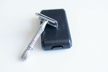 Vintage safety metal razor on a white background. Close-up. Isolated on white background. Reusable blade, zero waste product
