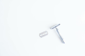 Vintage safety metal razor on a white background. Close-up. Isolated on white background. Reusable blade, zero waste product
