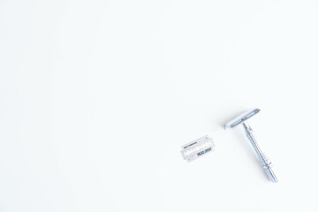 Vintage safety metal razor on a white background. Close-up. Isolated on white background. Reusable blade, zero waste product
