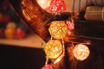 Colorful cotton ball light bulbs with bokeh background.