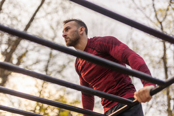 Man doing pullups in a street workout park