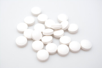 white pills on white