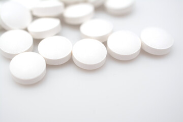 white pills on white