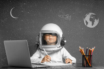 the child studies remotely at school, wearing an astronaut's helmet. back to school