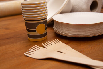 disposable tableware  on wooden table .concept of recycling and ecology.