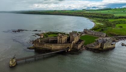 An aerial view from Blackness Bay inland past Blackness castle, Scotland on a summers day