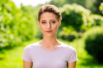 Portrait of attractive shine brown-haired girl spending spare time outside green forest wood outdoors