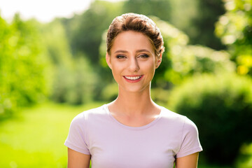 Portrait of attractive cheerful content brown-haired girl spending free time outside breathing fresh air outdoors