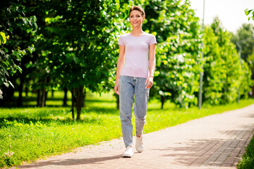Full length body size view of attractive cheerful girl walking street sun shining bright fresh air outdoors © deagreez