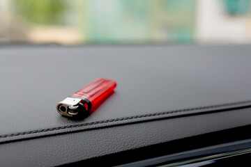 A red lighter is in the car.