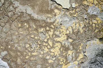 Old concrete wall with peeling plaster and cracks