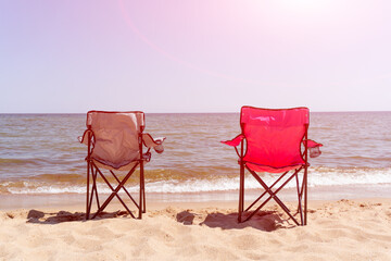 folding chairs on the sea sandy beach. camping. sunny.