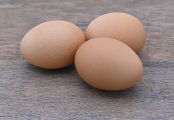 three eggs on wood close up