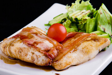 Tender zander in bacon: zander fillet, smoked bacon, pomegranate sauce narsharab, cucumbers, lettuce leaves