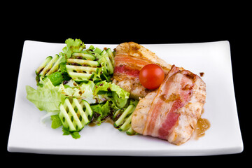 Tender zander in bacon: zander fillet, smoked bacon, pomegranate sauce narsharab, cucumbers, lettuce leaves