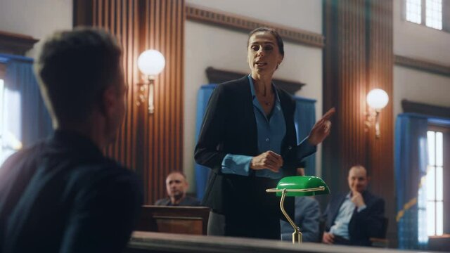Court of Justice and Law Trial: Female Public Defender Presenting Case, Asking Male Witness in Front of Judge and Jury. Multiethnic Attorney Lawyer Protecting Client Against Crime, Injustice.