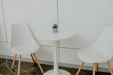 White table and chairs. Cafe interior in light colors.