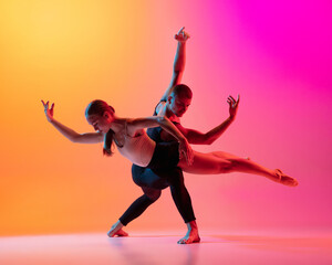 Two dancers, stylish sportive couple, male and female models dancing contemporary dance on colorful...