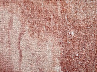 Textured Sandstone with Red and Pink Streaks on a Course Surface