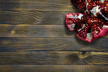 Fototapeta na wymiar cut pomegranate on a wooden table