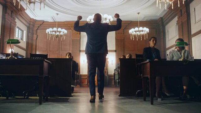 Court of Justice and Law Trial: Male Public Defender Wins the Case, Slowly Goes Away with Raised Hands. Successful African American Attorney Lawyer Serves Justice Once Again. Barrister's Work is Done.