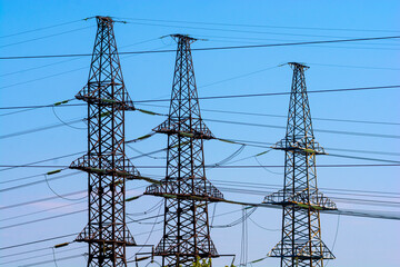 Power lines. High voltage towers against the blue sky.