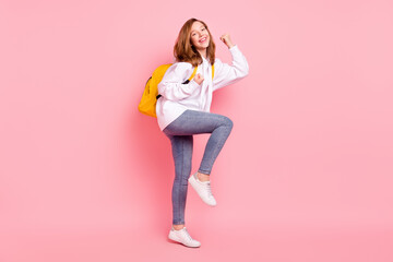 Full length body size view of pretty cheerful girl wearing bag rejoicing having fun isolated over pink pastel color background