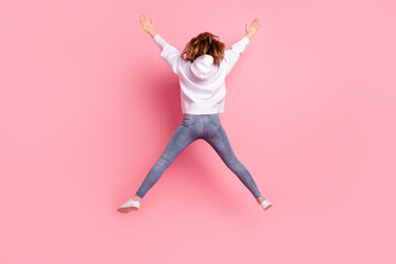 Fototapeta na wymiar Full length body size back view girl jumping high wearing casual clothes isolated pastel pink color background