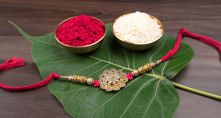 Raksha Bandhan festival Concept showing designer Rakhi or Wrist Band showing details over colourful background. Symbol of love between Brothers and Sisters. Selective focus.