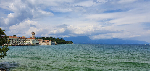 Sirmione Italy August 2021 View of Lake Garda and the mountains in beautiful weather with blue sky