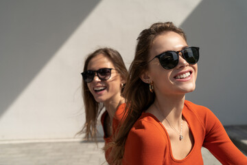 Portrait of smiling twin sisters. Enjoying their sisterhood and friendship