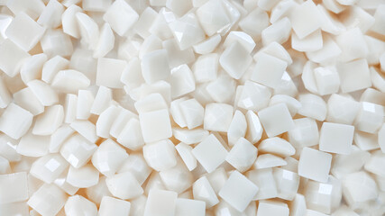 Close-up, white square diamonds for diamond embroidery. Hobbies and DIY, materials for creating diamond embroidery