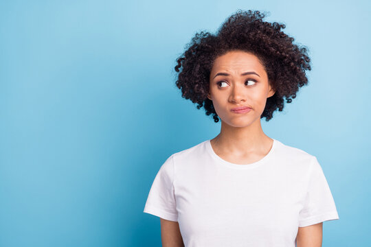 Portrait of young unhappy upset thoughtful minded afro girl look copyspace thinking isolated on blue color background