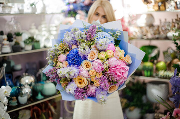 close-up of wonderful colorful bouquet of various fresh flowers wrapped in paper