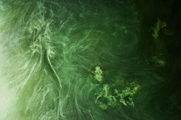 Abstract green color background. Swirling vibrant hookah smoke, underwater emerald ocean, dynamic paint in water