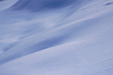 Snow drifts in frosty day. Winter landscape as a seasonal blue background.