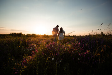 Lovely couple walking in the summer field