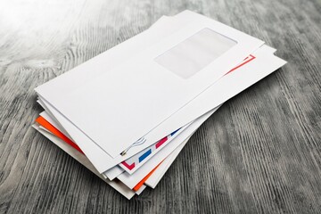 Pile of envelopes with overdue utility bills on the desk - obrazy, fototapety, plakaty