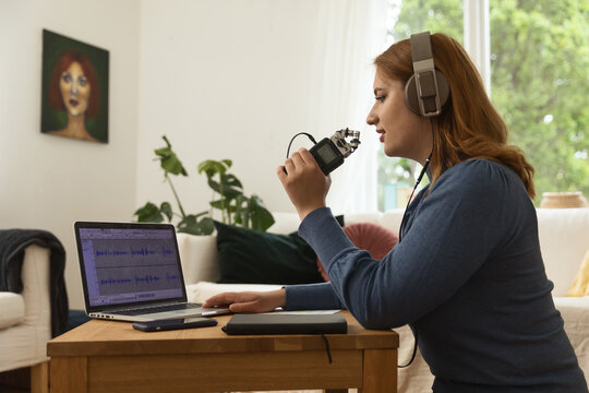 Woman recording podcast at home