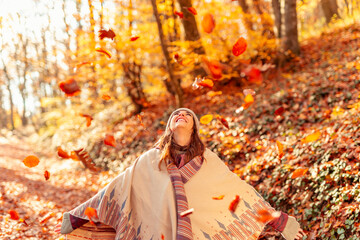 Woman watching the autumn leaves fall