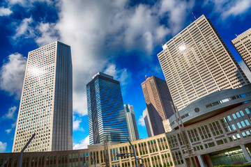 Fototapeta premium Tokyo urban cityscape, with high-rise office buildings. Blue sky and cloud background and HDR processing.