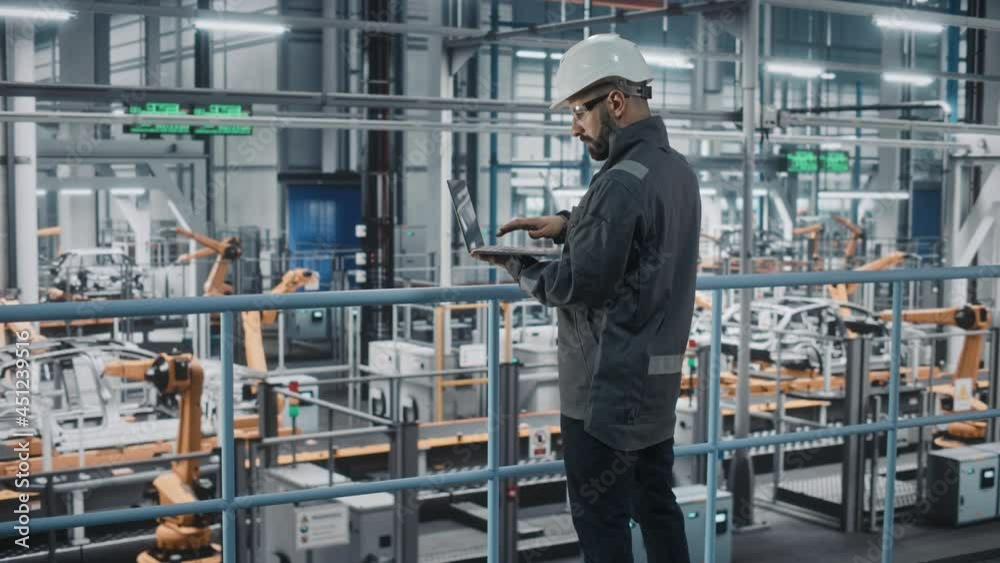 Poster car factory engineer in work uniform using laptop computer. automotive industrial manufacturing faci
