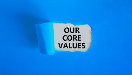 Our core values symbol. Words 'Our core values' appearing behind torn blue paper. Beautiful blue...