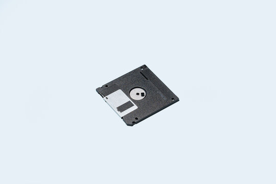 Black floppy disk on blue background