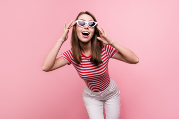 Photo of funky millennial brunette lady wear eyewear striped t-shirt isolated on pink color...
