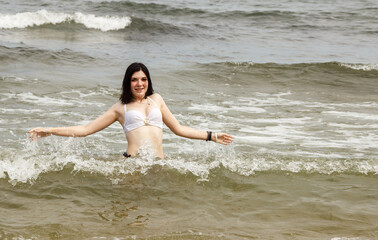 Fototapeta na wymiar young woman swims in the sea