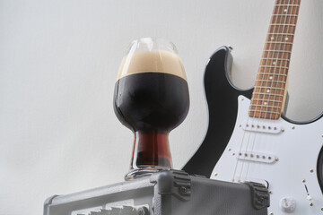 Tube combo or amplifier for guitar with black and white electric guitar and glass of stout beer...