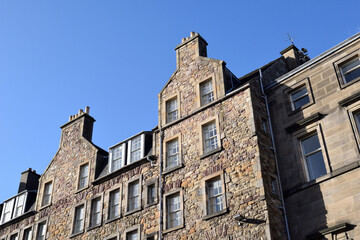 Exterior View of Old Stone Tenement Buildings against Blue Sky