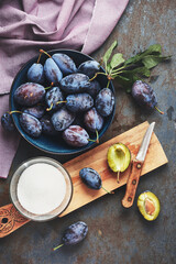 Freshly picked plums in a bowl.