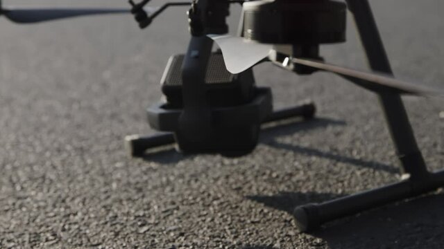 preparing a big drone RTK for flying over a roof to measure its size, changing Batteries, unfold the wings, camera 